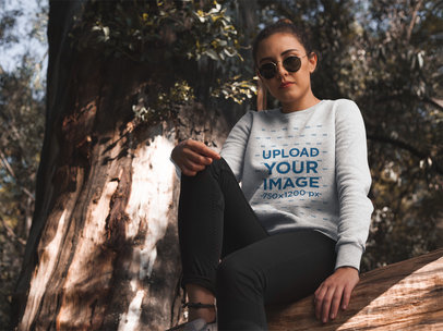 Placeit Woman Sitting on a Bench Wearing a Crew Neck Sweatshirt Template