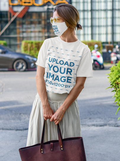 T-Shirt and Face Mask Mockup Featuring a Stylish Woman on the Street